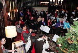 All join in singing Christmas carols led by musicians, including one in the TFP ceremonial habit.